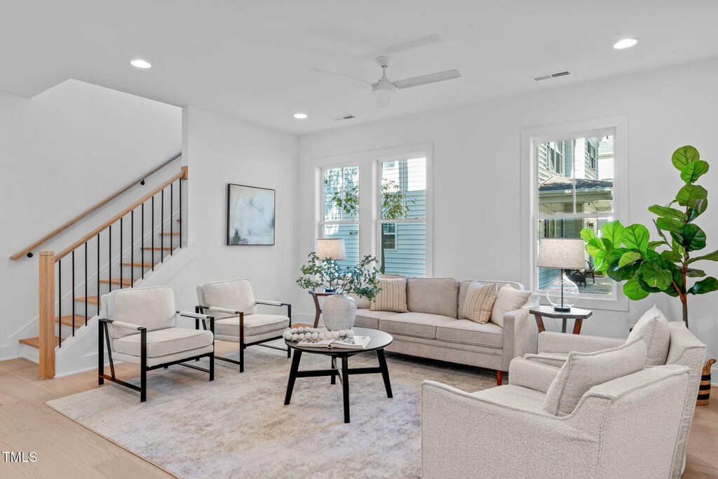 5041 Lundy Dr Unit 102, Raleigh, NC 27606 - living area with stairs, recessed lighting, ceiling fan, light wood-style floors, and baseboards
