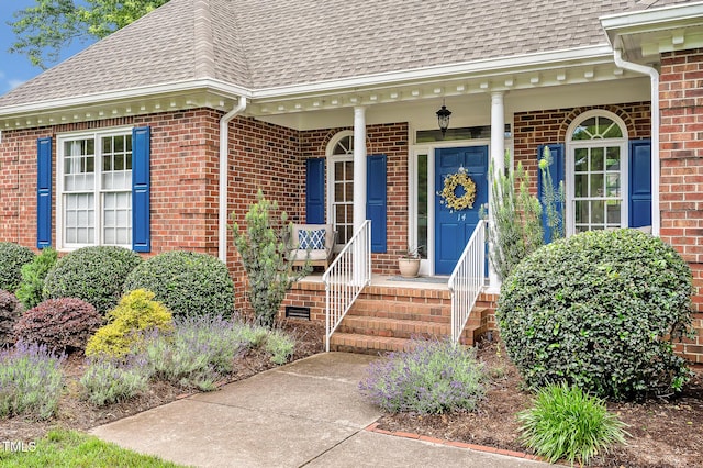 14 Marigold Pl, Durham, NC 27705 - property entrance featuring roof with shingles, brick siding, and a porch