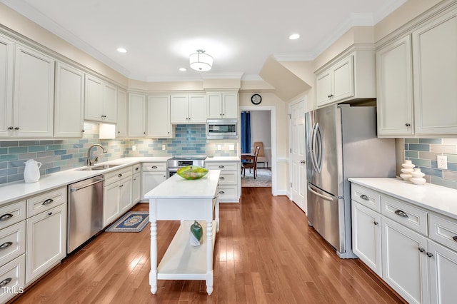 14 Marigold Pl, Durham, NC 27705 - kitchen featuring stainless steel appliances, a sink, decorative backsplash, light countertops, and crown molding