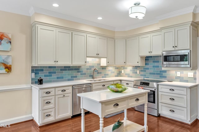 14 Marigold Pl, Durham, NC 27705 - kitchen with stainless steel appliances, a sink, light countertops, wood finished floors, and ornamental molding