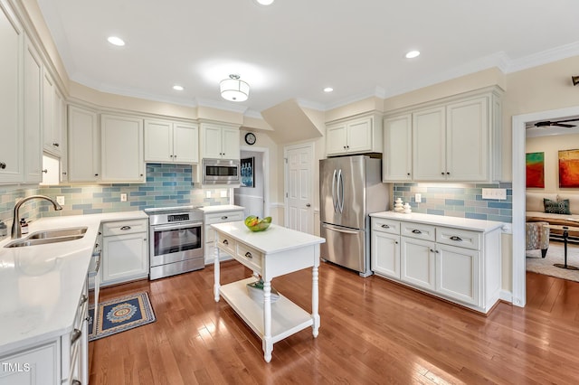14 Marigold Pl, Durham, NC 27705 - kitchen with stainless steel appliances, a sink, light countertops, ornamental molding, and tasteful backsplash