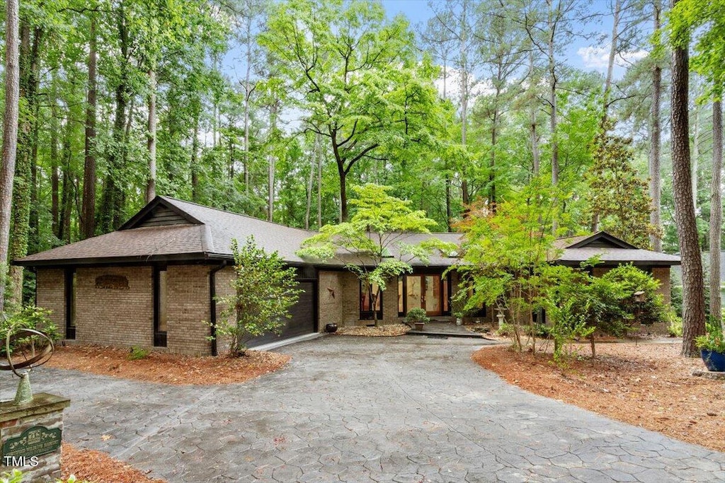 109 Loch Haven Ln, Cary, NC 27518 - view of front of home featuring driveway, roof with shingles, and brick siding