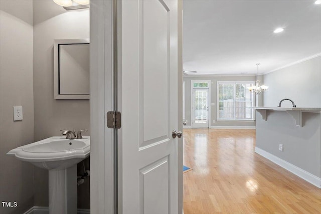 2822 Pickett Rd Unit 132, Durham, NC 27705 - bathroom with baseboards, wood finished floors, a chandelier, ornamental molding, and recessed lighting