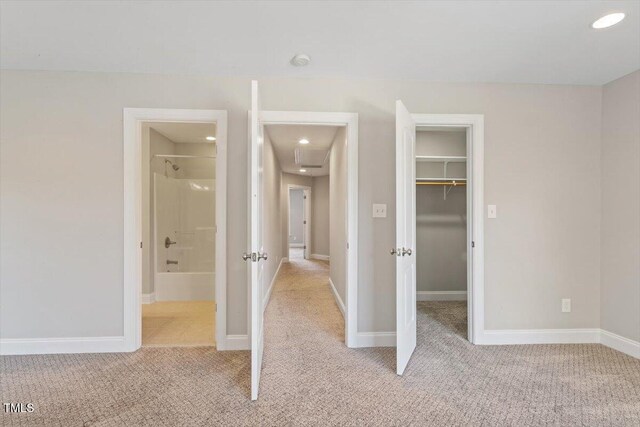 2822 Pickett Rd Unit 132, Durham, NC 27705 - unfurnished bedroom featuring light carpet, a spacious closet, a closet, recessed lighting, and baseboards