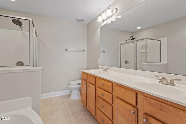 2822 Pickett Rd Unit 132, Durham, NC 27705 - bathroom featuring a shower stall, double vanity, tile patterned floors, toilet, and a tub