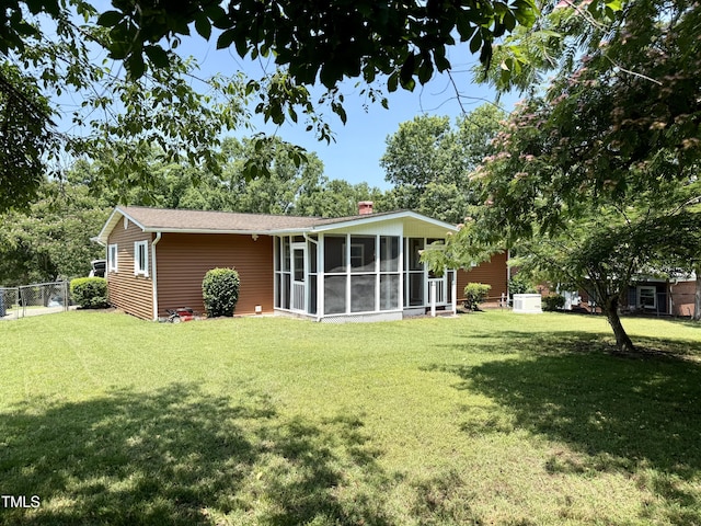 2909 Sprucewood Dr, Durham, NC 27707 - rear view of house with a chimney and a sunroom