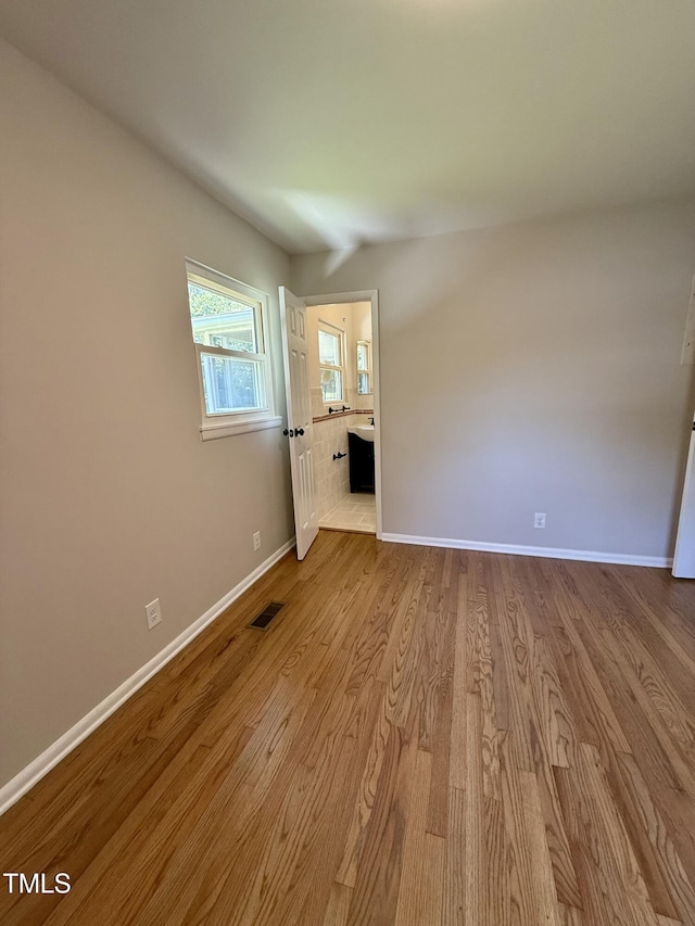 2909 Sprucewood Dr, Durham, NC 27707 - spare room featuring baseboards and wood finished floors