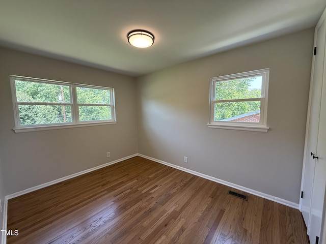2909 Sprucewood Dr, Durham, NC 27707 - spare room with healthy amount of natural light, wood finished floors, and baseboards