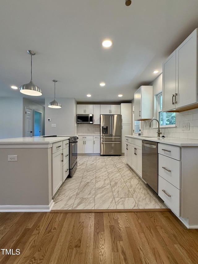 2909 Sprucewood Dr, Durham, NC 27707 - kitchen featuring appliances with stainless steel finishes, tasteful backsplash, light countertops, and recessed lighting