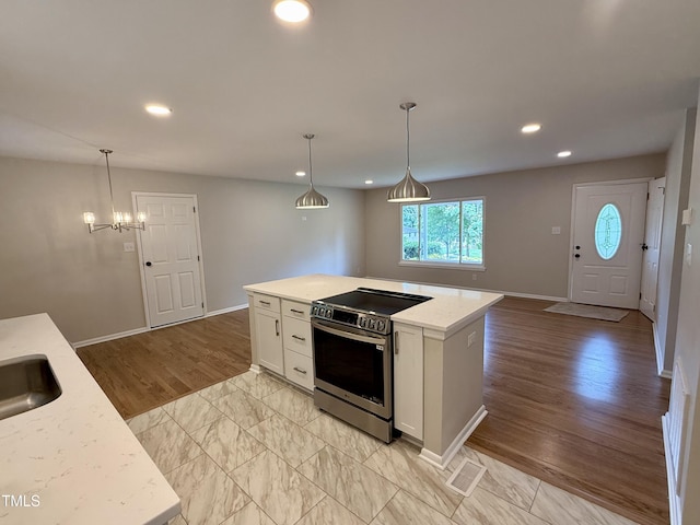 2909 Sprucewood Dr, Durham, NC 27707 - kitchen featuring electric stove, white cabinets, recessed lighting, pendant lighting, and baseboards
