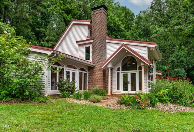 145 Ryan Rd, Pittsboro, NC 27312 - view of front facade featuring french doors, a chimney, and a front yard
