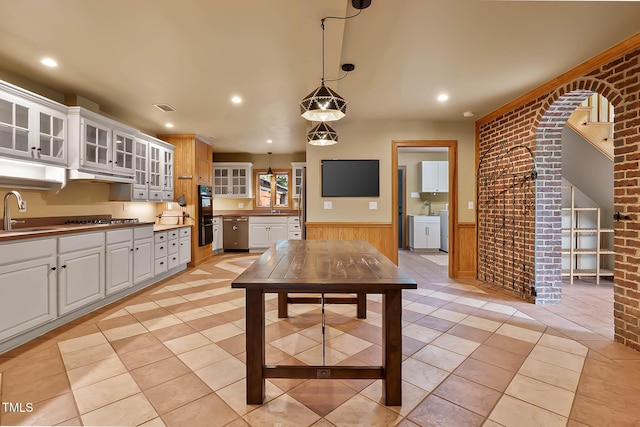145 Ryan Rd, Pittsboro, NC 27312 - kitchen featuring washing machine and clothes dryer, wainscoting, stainless steel appliances, white cabinetry, and light tile patterned floors