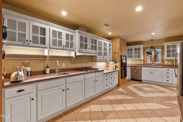 145 Ryan Rd, Pittsboro, NC 27312 - kitchen featuring stainless steel appliances, a sink, light tile patterned floors, recessed lighting, and white cabinetry