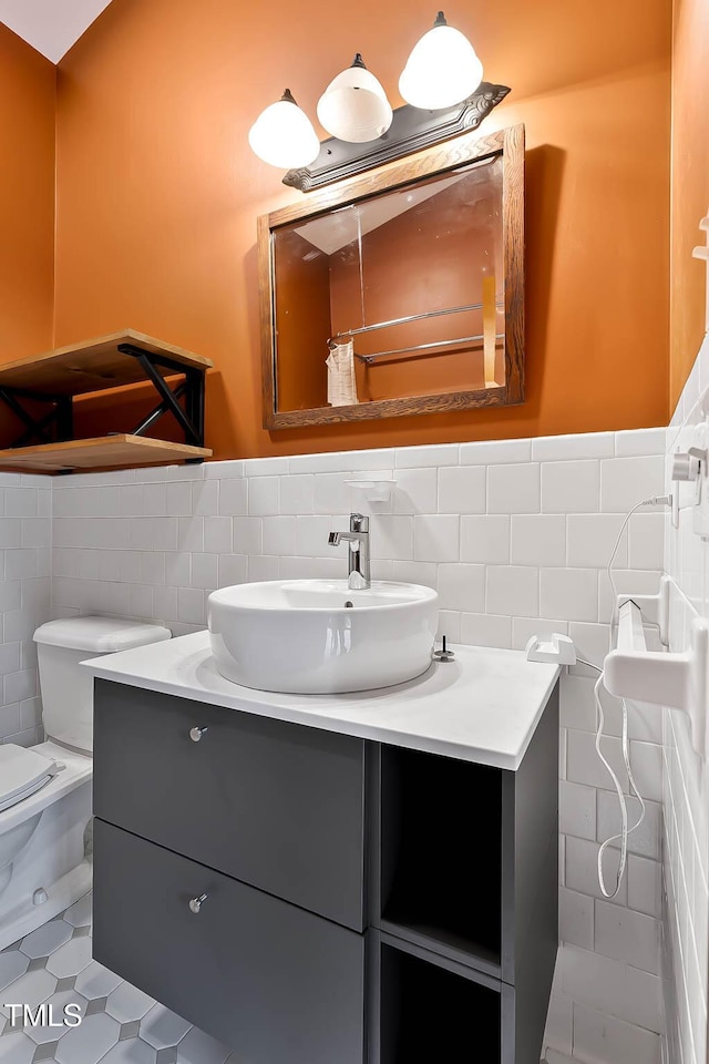145 Ryan Rd, Pittsboro, NC 27312 - full bath featuring tile walls, vanity, toilet, wainscoting, and tile patterned flooring