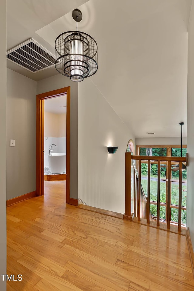 145 Ryan Rd, Pittsboro, NC 27312 - spare room with a chandelier, baseboards, and light wood finished floors