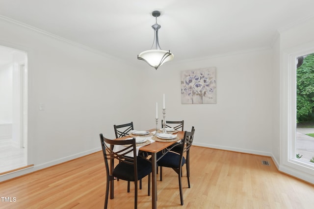 6617 Whitted Rd, Fuquay Varina, NC 27526 - dining room featuring crown molding, light wood finished floors, and baseboards