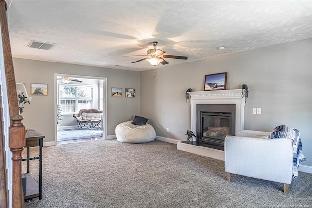 191 Trenton Pl, Cameron, NC 28326 - carpeted living area featuring ceiling fan, a glass covered fireplace, and baseboards
