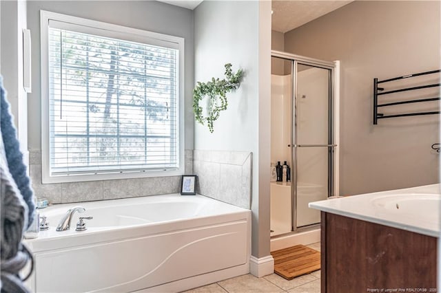 191 Trenton Pl, Cameron, NC 28326 - bathroom with plenty of natural light, a shower stall, a garden tub, and tile patterned floors