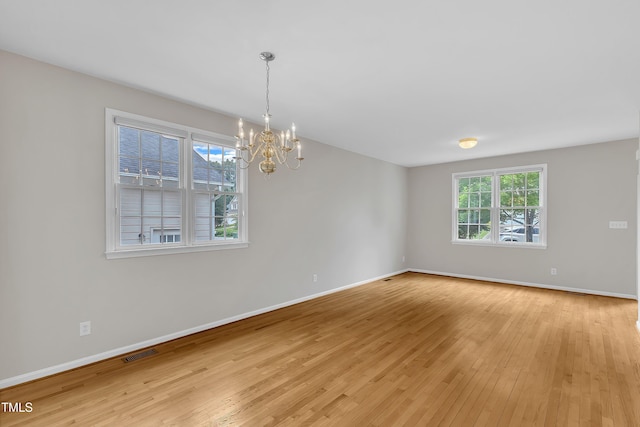 103 Kylie Savannah Ct, Cary, NC 27511 - spare room with light wood finished floors, a chandelier, and baseboards