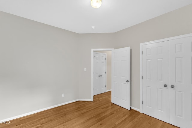 103 Kylie Savannah Ct, Cary, NC 27511 - unfurnished bedroom with light wood finished floors, baseboards, and a closet