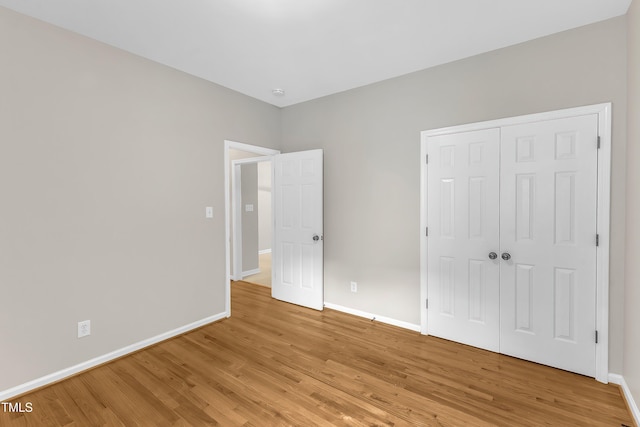 103 Kylie Savannah Ct, Cary, NC 27511 - unfurnished bedroom featuring baseboards, light wood-style floors, and a closet