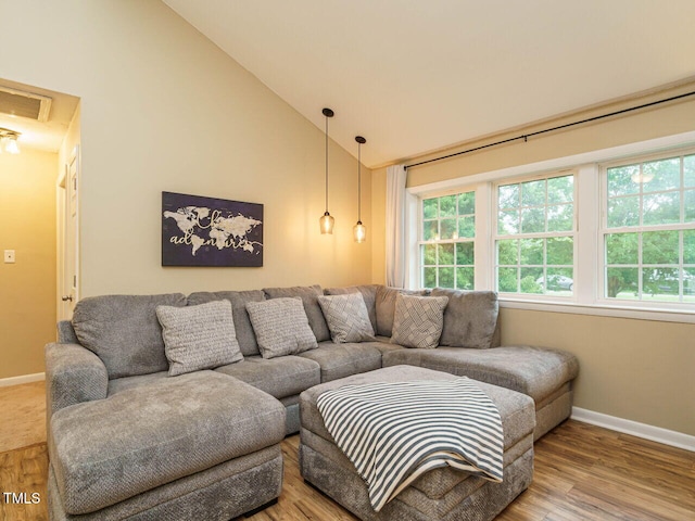 8204 Charlbert Ct, Apex, NC 27539 - living area with baseboards, wood finished floors, and high vaulted ceiling