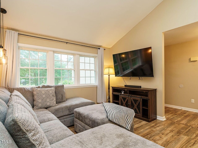 8204 Charlbert Ct, Apex, NC 27539 - living area featuring wood finished floors, baseboards, and high vaulted ceiling