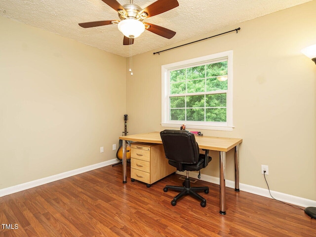 8204 Charlbert Ct, Apex, NC 27539 - home office featuring a textured ceiling, wood finished floors, baseboards, and a ceiling fan