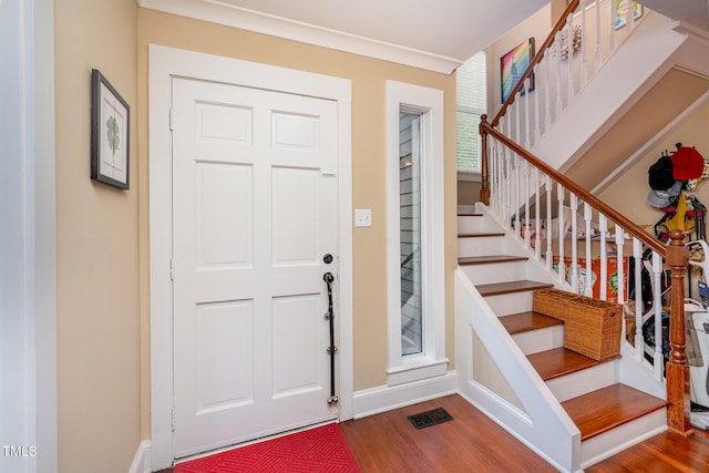 6035 Sentinel Dr, Raleigh, NC 27609 - foyer entrance featuring wood finished floors, stairs, and baseboards