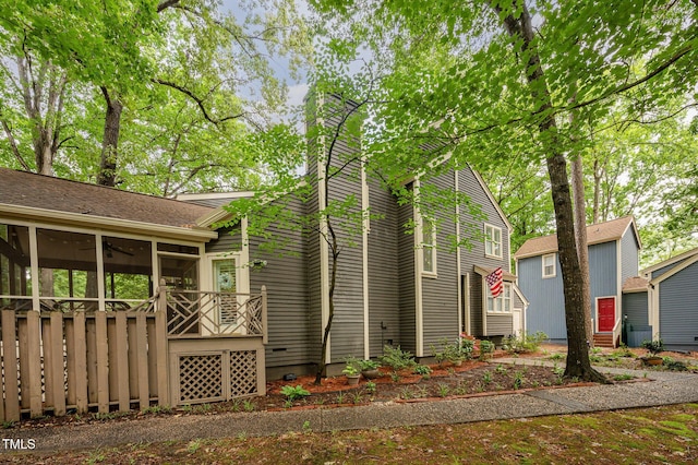6035 Sentinel Dr, Raleigh, NC 27609 - view of side of home with a sunroom, a chimney, and a ceiling fan