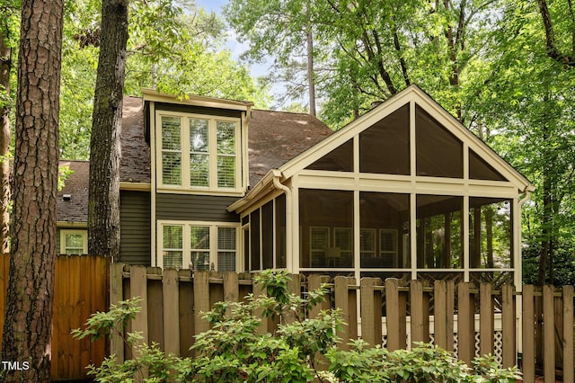 6035 Sentinel Dr, Raleigh, NC 27609 - rear view of house featuring roof with shingles and a sunroom