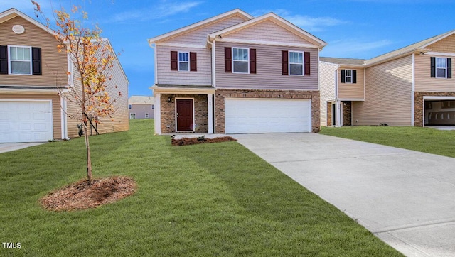 2132 Monk Dr, Haw River, NC 27258 - view of front of house with an attached garage, concrete driveway, a front lawn, and brick siding