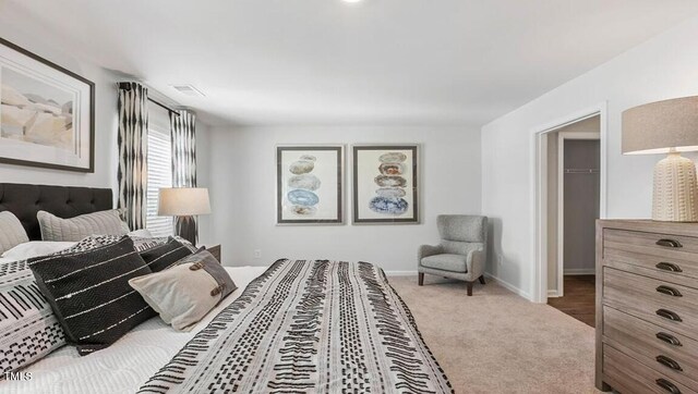 2132 Monk Dr, Haw River, NC 27258 - bedroom with a walk in closet, carpet, baseboards, and a closet