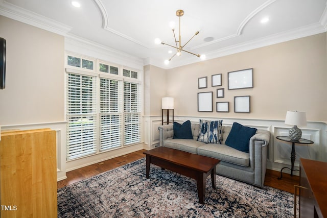 3748 Westbury Lake Dr, Raleigh, NC 27603 - living area featuring ornamental molding, a chandelier, wainscoting, wood finished floors, and a decorative wall
