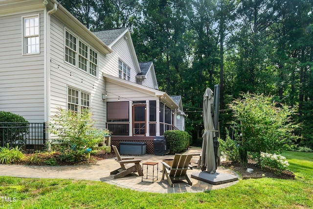 3748 Westbury Lake Dr, Raleigh, NC 27603 - back of house featuring a patio area, a sunroom, a yard, and roof with shingles