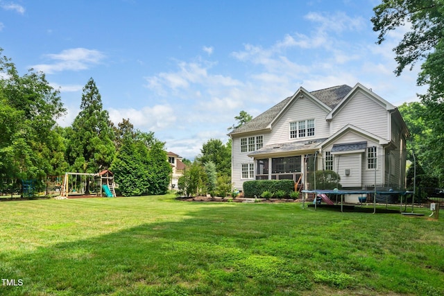 3748 Westbury Lake Dr, Raleigh, NC 27603 - view of grassy yard featuring a trampoline, a playground, and a sunroom