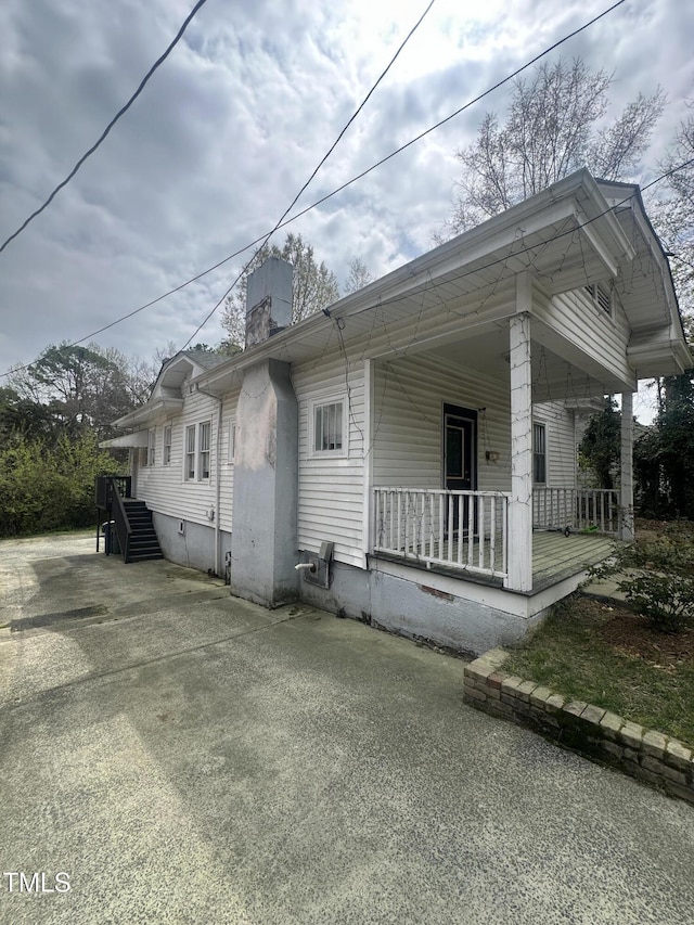 2511 Chapel Hill Rd, Durham, NC 27707 - view of side of home featuring a porch and a chimney