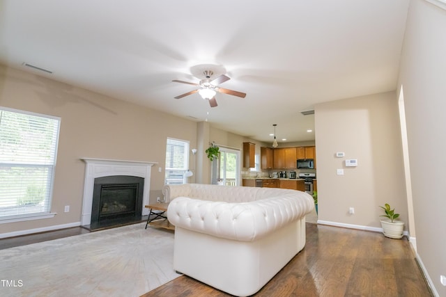 110 Elmsford St, Durham, NC 27707 - living room with a ceiling fan, wood finished floors, a glass covered fireplace, baseboards, and recessed lighting