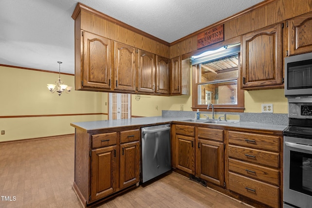5437 Grasshopper Rd, Raleigh, NC 27610 - kitchen with stainless steel appliances, a sink, crown molding, a peninsula, and brown cabinets