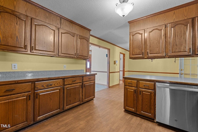 5437 Grasshopper Rd, Raleigh, NC 27610 - kitchen with stainless steel dishwasher, ornamental molding, brown cabinets, light wood-style flooring, and a textured ceiling