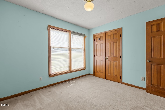 5437 Grasshopper Rd, Raleigh, NC 27610 - unfurnished bedroom with baseboards, carpet, a closet, and a textured ceiling