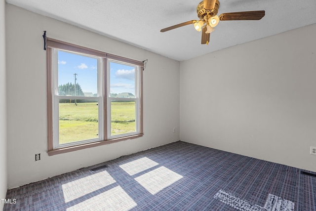 5437 Grasshopper Rd, Raleigh, NC 27610 - spare room featuring dark carpet and a ceiling fan
