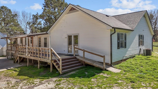 5437 Grasshopper Rd, Raleigh, NC 27610 - back of property with a shingled roof, a deck, and central air condition unit