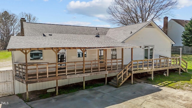 5437 Grasshopper Rd, Raleigh, NC 27610 - rear view of house featuring a shingled roof, a chimney, and a wooden deck