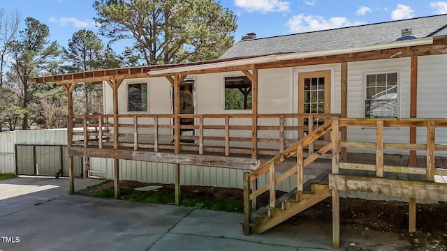 5437 Grasshopper Rd, Raleigh, NC 27610 - rear view of house featuring a shingled roof, a wooden deck, and a chimney