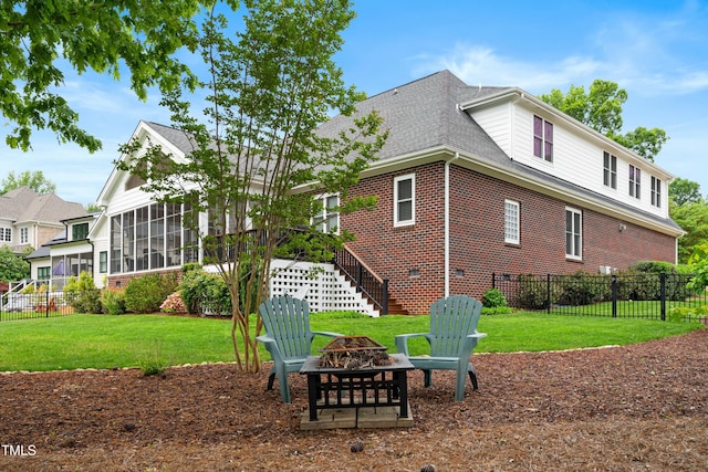 498 Mountain Laurel, Chapel Hill, NC 27517 - rear view of property featuring a fire pit, brick siding, a sunroom, and a shingled roof