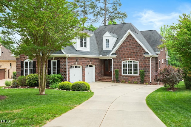 498 Mountain Laurel, Chapel Hill, NC 27517 - view of front facade with brick siding, driveway, a front lawn, and a shingled roof