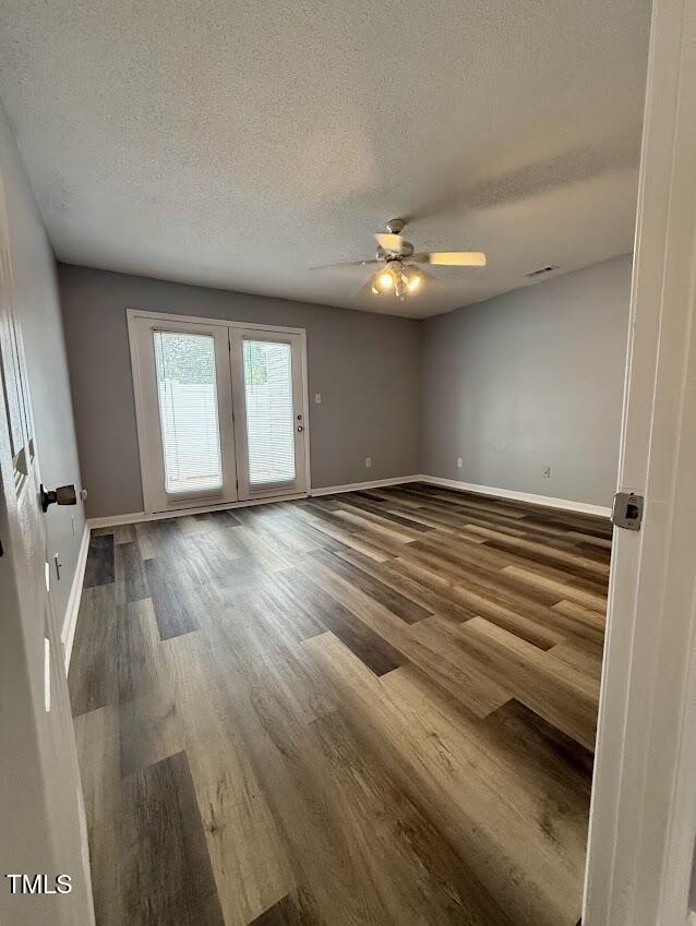 5071 Avenida Del Sol Dr, Raleigh, NC 27616 - unfurnished room with wood finished floors, baseboards, ceiling fan, and a textured ceiling