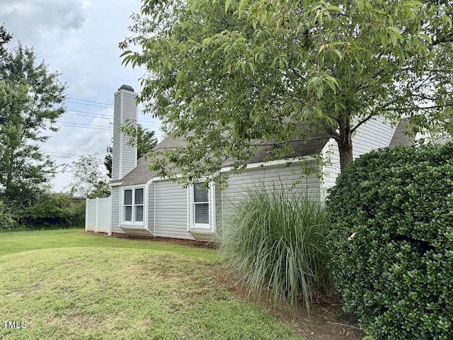 5071 Avenida Del Sol Dr, Raleigh, NC 27616 - view of side of home featuring a yard and a chimney