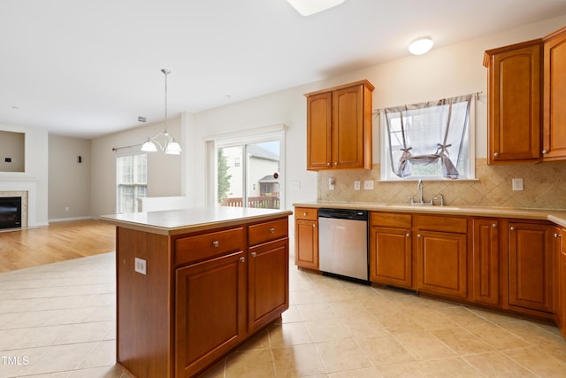 1405 Merrilow Ct, Wake Forest, NC 27587 - kitchen with stainless steel dishwasher, a sink, light tile patterned floors, light countertops, and decorative backsplash